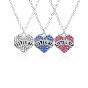 Detail of heart pendants with crystals and LITTLE SIS engraving on silver link chains