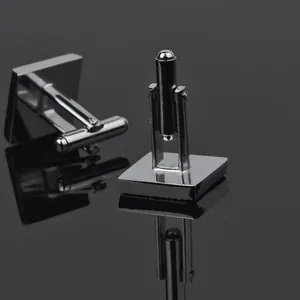 Polished square silver cufflinks for men with T-shaped rotating clasp on black background