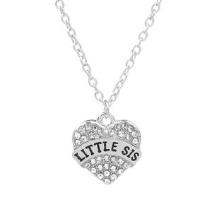 Detail of silver heart pendant with LITTLE SIS engraving and pave cubic zirconia