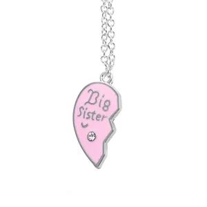 Detail of pink enamel heart pendant with Big Sister engraving and sparkling crystal