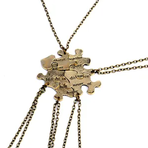 Set of four antique bronze puzzle heart necklaces with engraved Best Friends quote