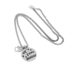 Silver stainless steel necklace with All Paws Matter round tag and paw print charm