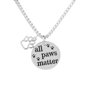 Silver dog tag necklace with All Paws Matter engraving and paw print charm pendant
