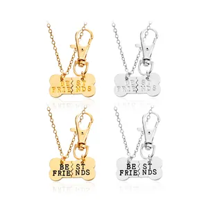 Splittable gold and silver dog bone necklaces with Best Friends engraving on white background
