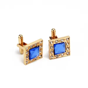 Macro shot of square blue zircon cufflinks with gold plating and white crystal halo