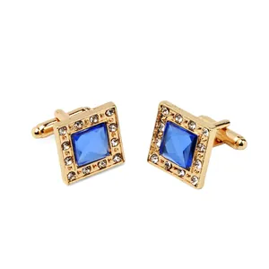 Men's square gold-plated cufflinks featuring a large blue gemstone with crystal halo