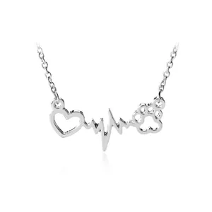 Silver heartbeat necklace with hollow heart and animal paw print pendant on white background