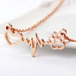 Close-up of rose gold heartbeat necklace with integrated heart and animal paw pendant