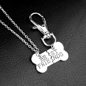 Close-up of split bone pendant with Best Friends engraving on black leather background