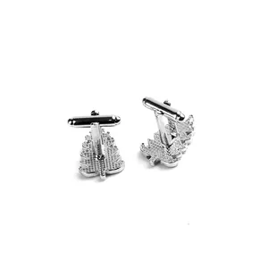 Macro shot of silver metal Christmas tree cufflinks with textured surface and T-bar clasp