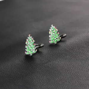 Detail of Christmas tree cufflinks with green enamel and sparkling rhinestones on leather
