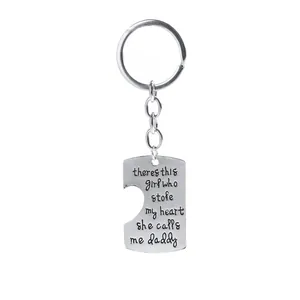 Detail of silver heart keychain with engraved quote: she stole my heart she calls me daddy