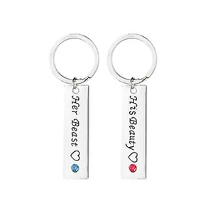 Detail of Her Beast and His Beauty couple keychains with gems and heart engraving