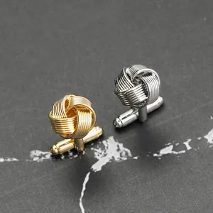 Boutons de manchette nœud tissé or et argent avec fermoir pivotant sur fond en pierre