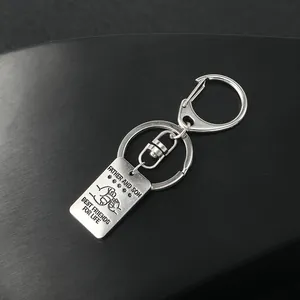 Macro view of silver stainless steel keychain engraved with father and son fist bump