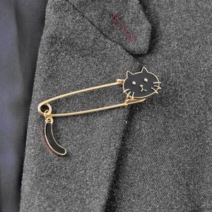 Creative black enamel cat brooch with swaying tail pinned on a dark grey suit jacket