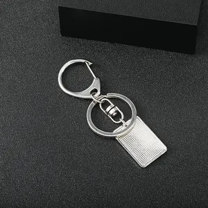 Polished silver keychain with D-clasp and rectangular plate featuring grid texture