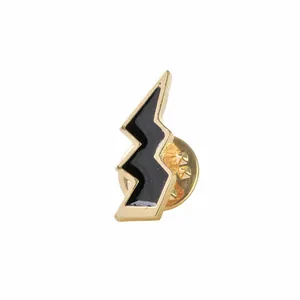 Close-up of lightning bolt enamel lapel pin with gold metal frame and black filling