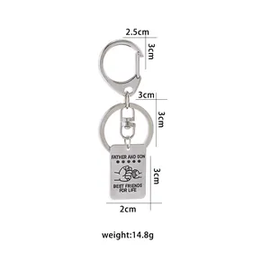 Polished silver keychain with engraved Father and Son fist bump and inspirational text
