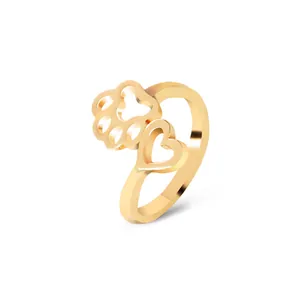 Minimalist gold open ring featuring hollow heart and dog paw prints on a white background