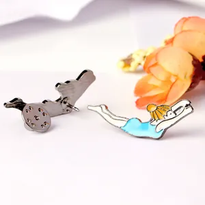 Detailed macro view of the enamel swimming girl brooch and the silver butterfly clasp backing