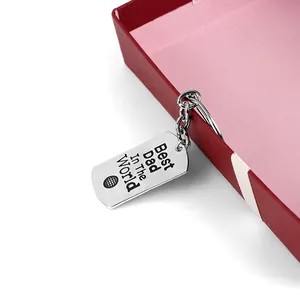Close-up of Best Dad In The World engraved keychain with basketball on red gift box