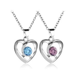Elegant silver heart necklace with blue and purple rhinestone pendants on white background