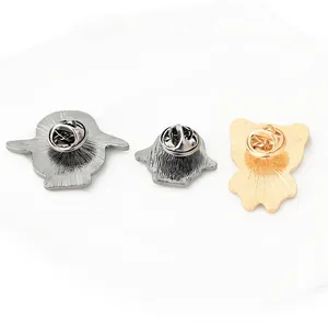 Detailed back view of metal animal pins showing texture and butterfly clutches