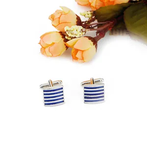 Detailed macro view of square men's cufflinks with silver and navy blue enamel stripes