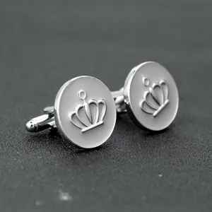 Detail of silver crown cufflinks with grey enamel inlay and secure toggle back closure
