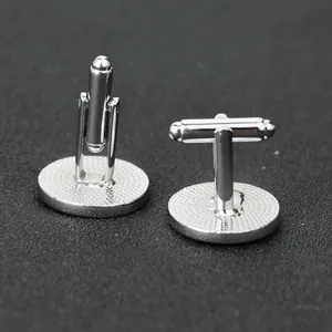 Macro detail of silver cufflinks showing the T-shaped swivel back and anti-slip mesh base