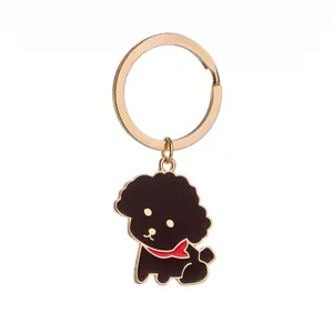 Portachiavi cane Teddy dorato con finitura in smalto nero e dettaglio sciarpa rossa