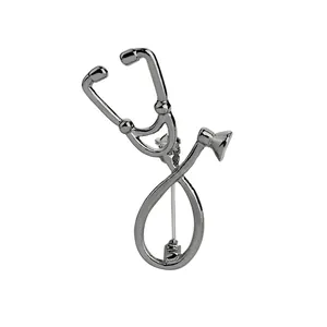 Detailed close-up of a silver stethoscope brooch with polished metal finish and clasp