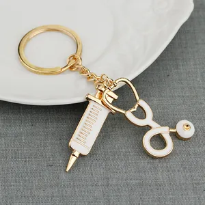Golden medical syringe and stethoscope enamel keychain pendant for doctors and nurses