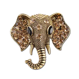 Vintage elephant brooch in antique gold metal with champagne rhinestones and black gem eyes