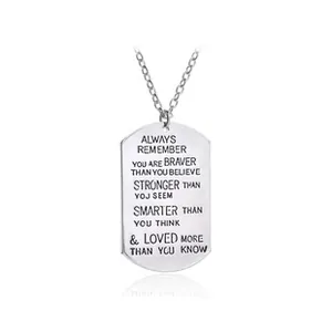Detailed view of polished silver dog tag pendant with engraved inspirational message