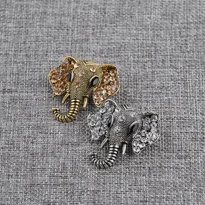 Detailed macro view of retro elephant brooches in gold and silver with crystal rhinestones