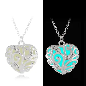 Luminous heart pendant necklace showing glow-in-the-dark effect and intricate filigree details