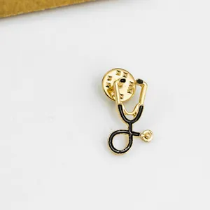 Broche stéthoscope vintage en émail noir et métal doré avec fermoir papillon pour infirmiers