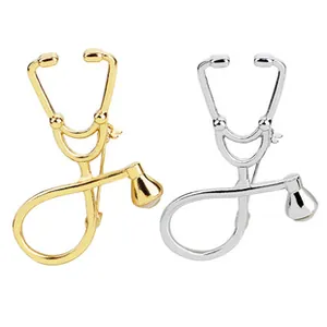 Detail view of gold and silver stethoscopes brooch pins for medical professionals