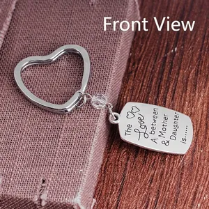 Polished alloy heart keychain with Mother and Daughter quote on a purple fabric background