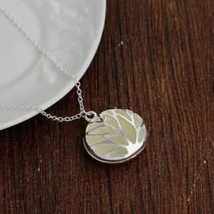 Detailed view of the Tree of Life pendant featuring intricate hollow carvings and chain