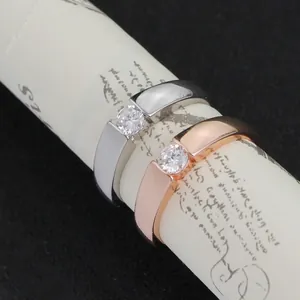 Minimalist silver and rose gold couple rings with tension-set round zircon crystals