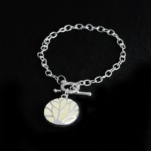 Detailed view of the life tree toggle bracelet with glowing resin inlay on black background
