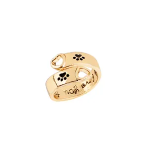 Detailed macro view of gold heart cutout ring featuring paw prints and Love you engraving