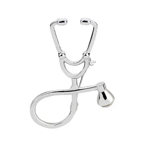 Macro shot of silver medical stethoscope brooch pin with polished metal finish