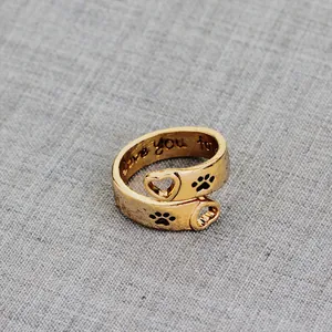 Detail of gold wrap ring with heart claw cutouts and I love you forever engraving