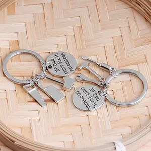 Close-up of Father's Day keychain set with mini tools and engraved silver metal tag