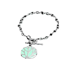 Silver Tree of Life toggle clasp necklace with glowing green pendant on white background