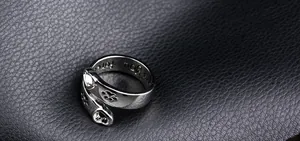 Detail of engraved I will love you forever text and heart paw design on silver ring
